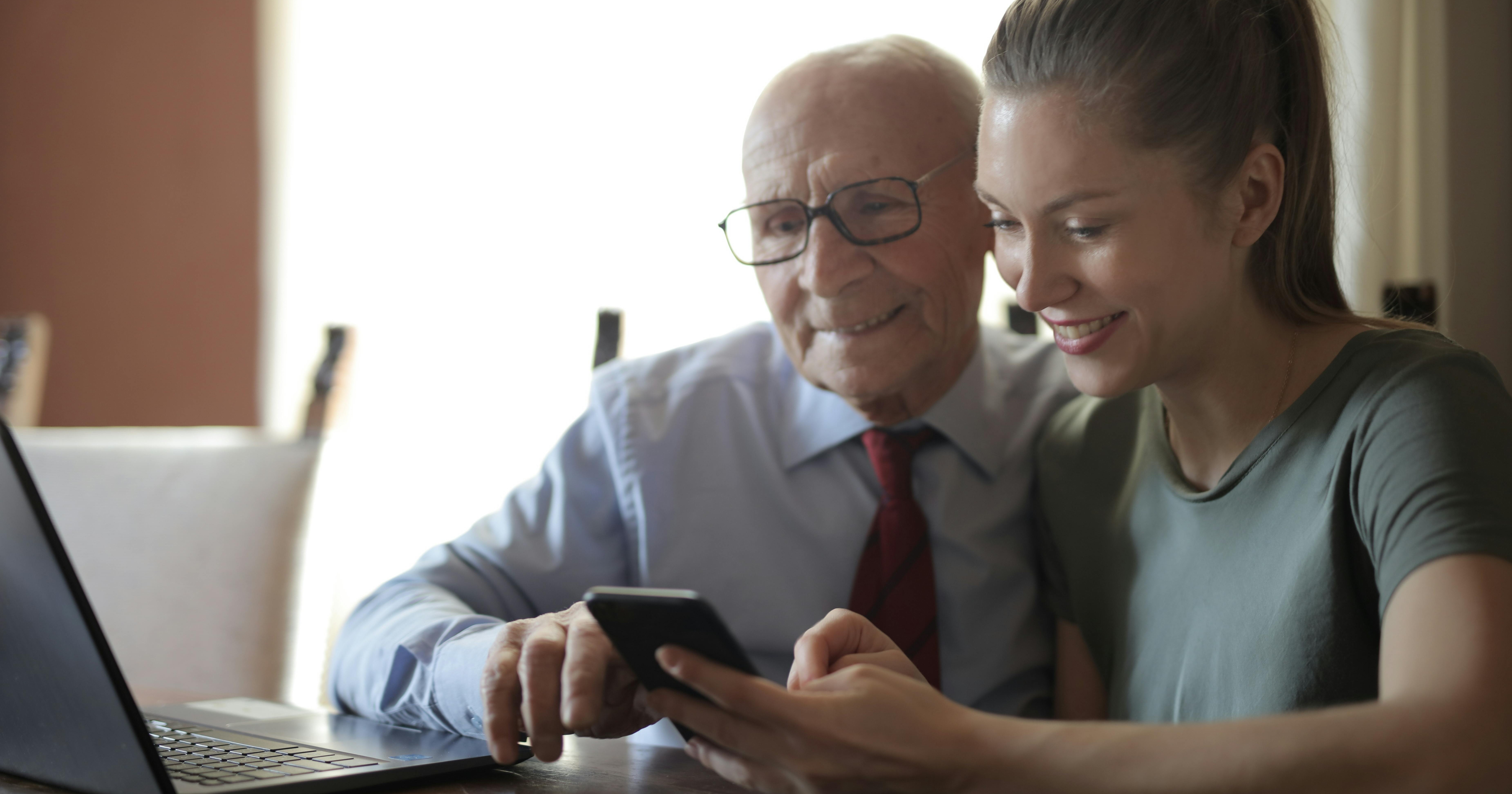 "Elderly man and woman with phone"